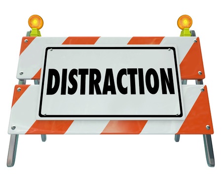 39940541 - distraction word on a road construction barrier or sign to illustrate dangerous inattentive driving or hazardous situation